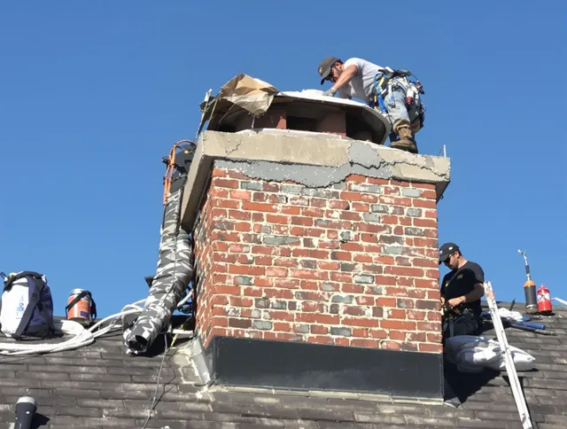 Longmeadow Chimney Sweep installing a custom chimney crown in Longmeadow, MA