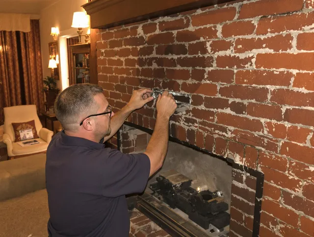 Longmeadow Chimney Sweep expert fixing a fireplace in Longmeadow, MA